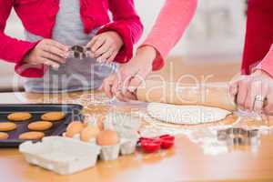 Festive mother and daughter making christmas cookies