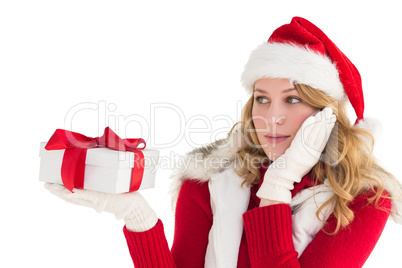 Pretty woman holding gift in a hand