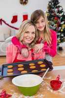 Festive little girl making christmas cookies