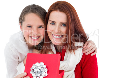 Mother and daughter opening christmas gift Mother and daughter opening christmas gift