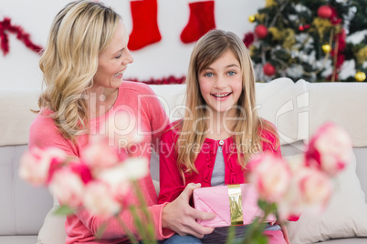 Mother giving her daughter a christmas gift