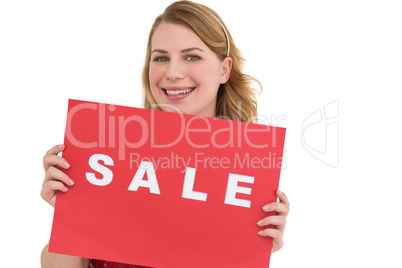 Cute blonde showing a red sale poster
