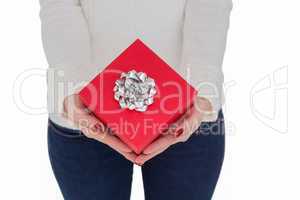 Woman with nail varnish holding red gift
