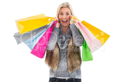 Blonde in winter clothes holding shopping bags