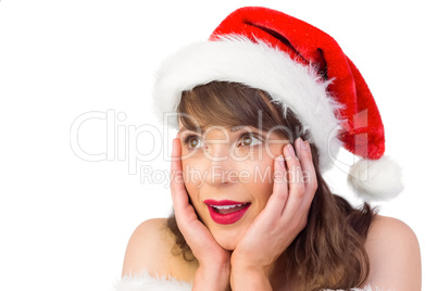 Pretty santa girl with hands on face