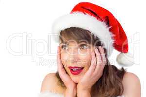 Pretty santa girl with hands on face