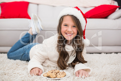 Festive little girl eating cookies