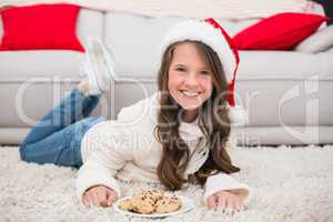 Festive little girl eating cookies