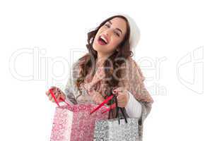 Happy brunette opening shopping bag