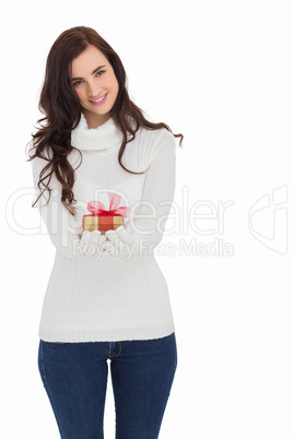 Smiling brunette in white gloves holding gift