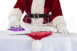 Father Christmas is ironing his hat