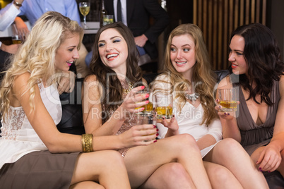 Pretty friends having a drink together