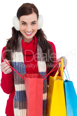 Brunette in winter clothes holding shopping bags