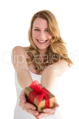Smiling blonde offering a small gift