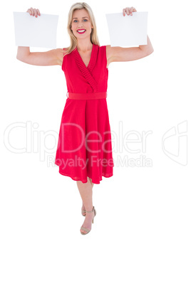 Stylish blonde in red dress holding pages