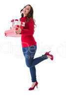 Happy brunette in winter clothes holding presents