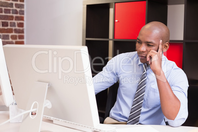 Businessman looking at computer monitor in office