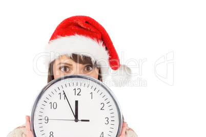 Festive brunette holding a clock
