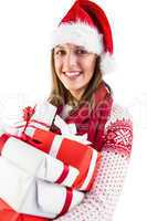 Festive brunette with santa hat holding many gifts