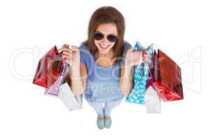 Happy brunette holding shopping bags