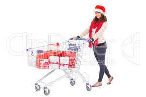 Brunette in santa hat with shopping trolley