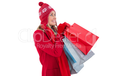Blonde in winter clothes holding shopping bags