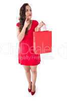Brunette thinking and holding shopping bag