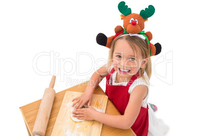 Festive little girl making cookies