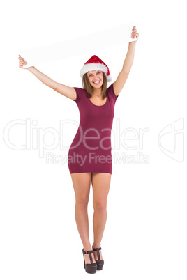 Girl standing upright while holding a poster above her head