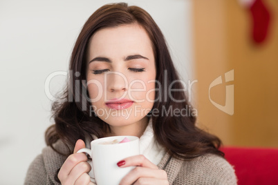 Brunette enjoying a hot chocolate with marshmallow