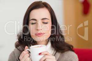 Brunette enjoying a hot chocolate with marshmallow