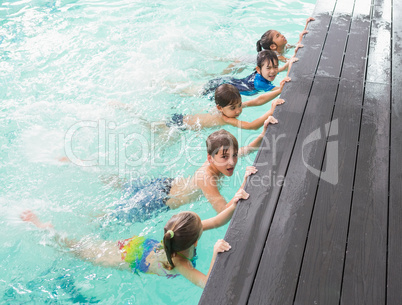 Cute swimming class in the pool