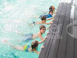 Cute swimming class in the pool