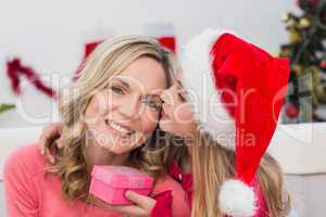 Festive mother and daughter with gift