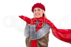 Blonde in winter clothes with hands out