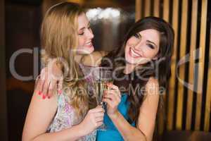 Attractive friends toasting with champagne