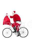 Santa cycling and holding his sack