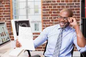 Businessman looking at document in office