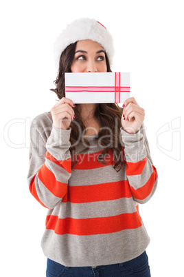 Festive brunette holding a gift