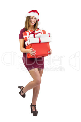 Festive brunette holding pile of gifts