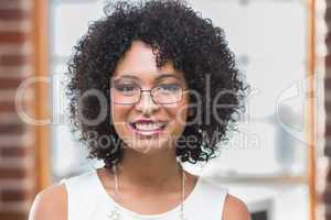 Smiling young businesswoman in office