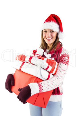 Festive brunette with santa hat holding many gifts