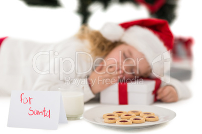 Festive little girl napping on a gift