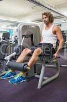 Young man doing leg workout at gym