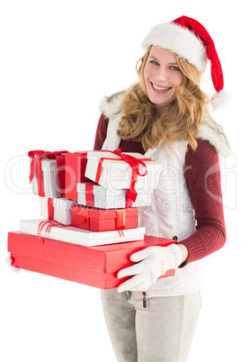 Festive blonde holding pile of gifts