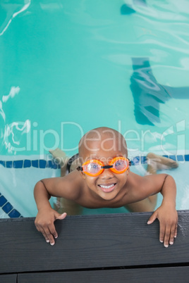 Cute little boy smiling up at the pool