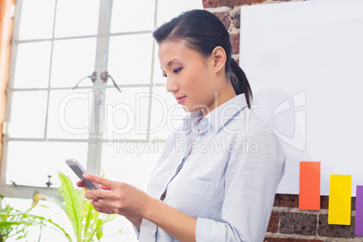 Concentrated businesswoman using digital tablet in office