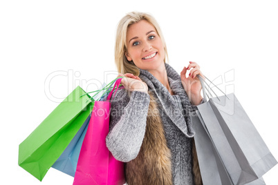 Blonde in winter clothes holding shopping bags