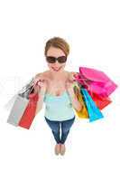 Woman holding shopping bags wearing sunglasses
