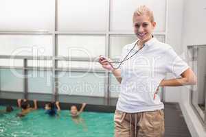 Pretty swimming coach smiling at camera